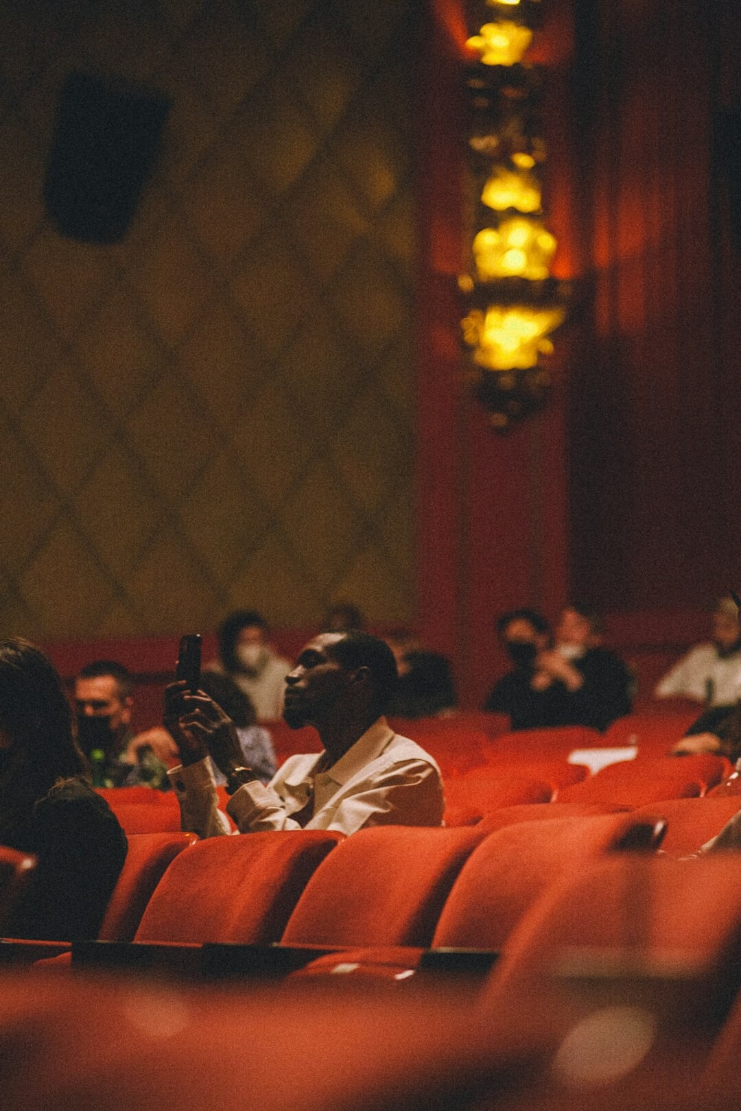 Croatian pensioners sitting in a theatre audience enjoying a play