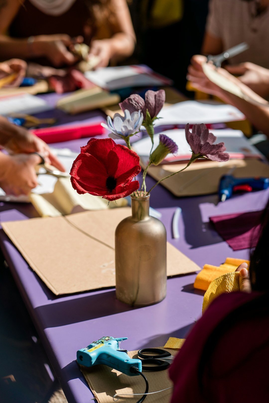 Group of Croatian pensioners attending a craft workshop at a table