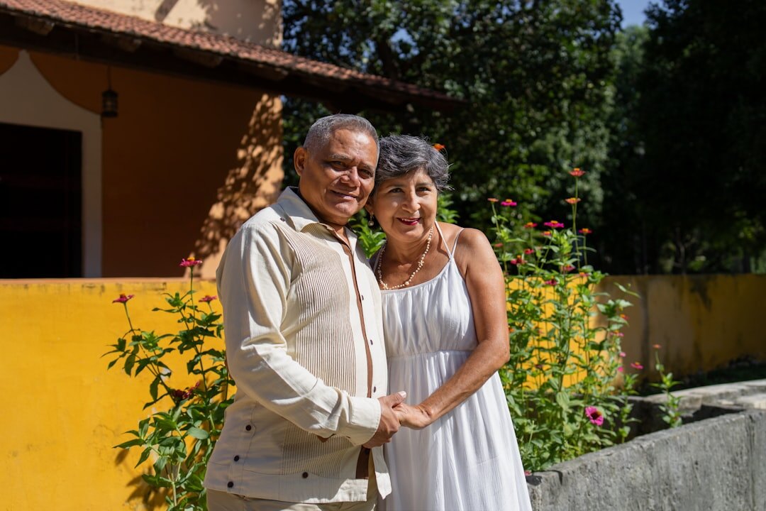 Happy Croatian senior couple holding a membership card outdoors